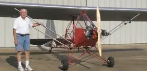 man posing near red plane
