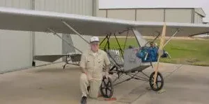 man posing near grey plane