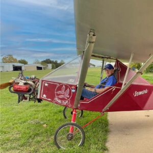 A Man in a Double-Eagle Red Color Plane
